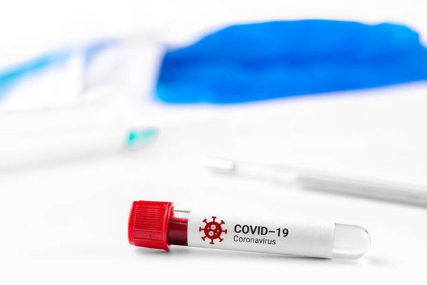 Test tube with blood test for coronavirus 2019-nCov. Covid-19 respiratory disease outbreak. SARS. - Foto, afbeelding