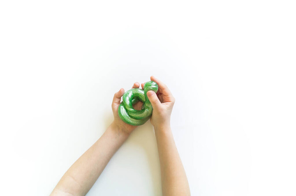 lime in the hand of a child. White background. - Foto, Bild