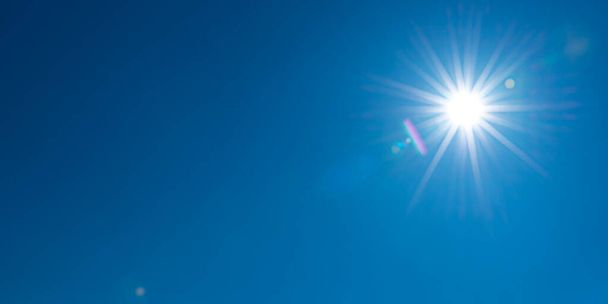 Sun, sunbeams against blue sky - cloudless sky. Photography with Lense flair effect - Photo, Image