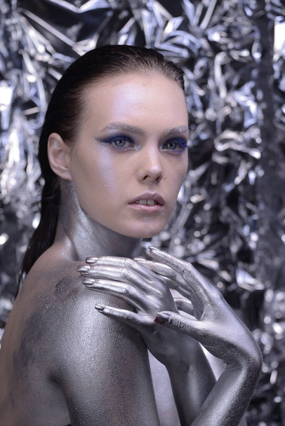 Young woman in creative image with silver artistic make-up. - Foto, immagini