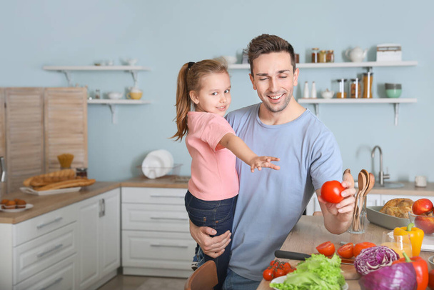 Father with daughter cooking together in kitchen - Φωτογραφία, εικόνα