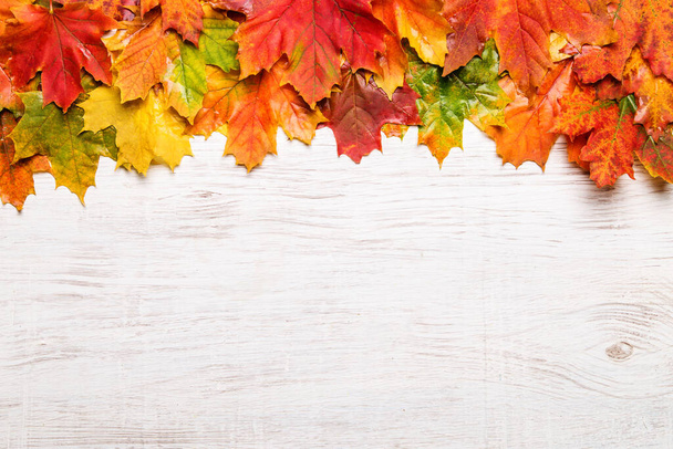 Autumn leaves on the wooden background. Copy space for text. - Photo, image