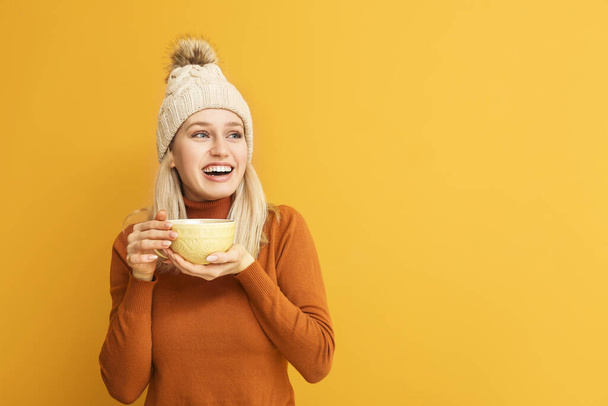 Beautiful young woman with tea on color background - Photo, Image