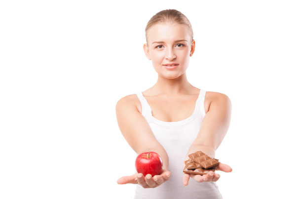 Woman holding apple and chocolate isolated - Foto, Imagem
