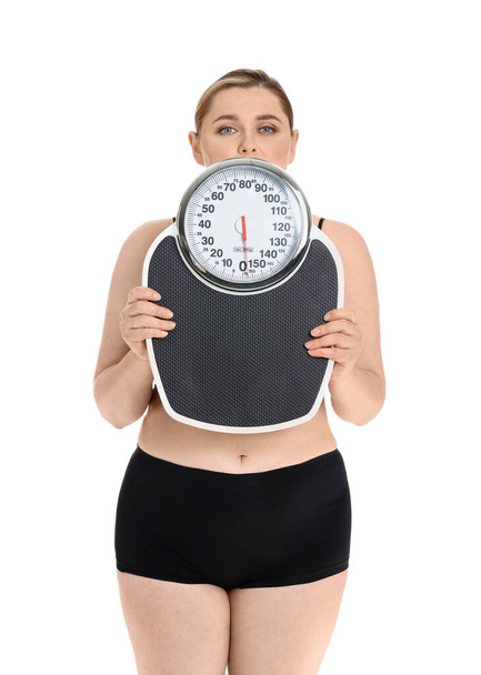 Overweight woman with scales on white background. Weight loss concept - Foto, imagen