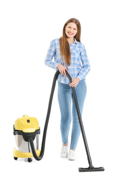 Young woman with vacuum cleaner on white background - Fotografie, Obrázek