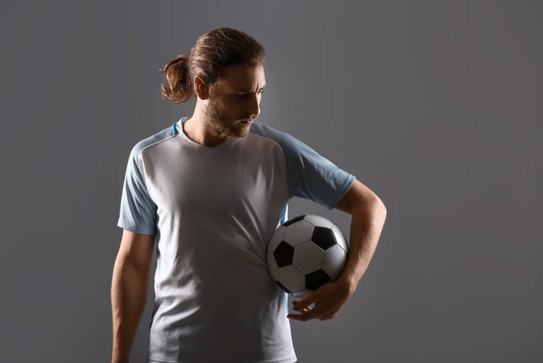 Silhueta de jogador de futebol masculino no fundo escuro
 - Foto, Imagem