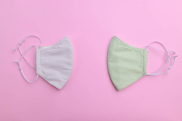 design of white and green face mask handmade sewing from fashion fabric cotton cloth on pink background - Valokuva, kuva