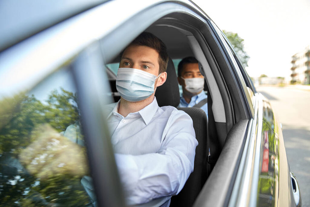 taxi driver in face protective mask driving car - Photo, image