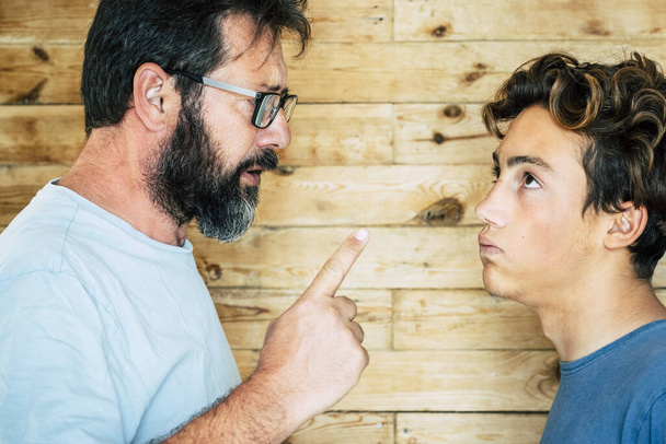 Adulto caucasiano homem pai dizendo seu filho adolescente em casa
  - Foto, Imagem