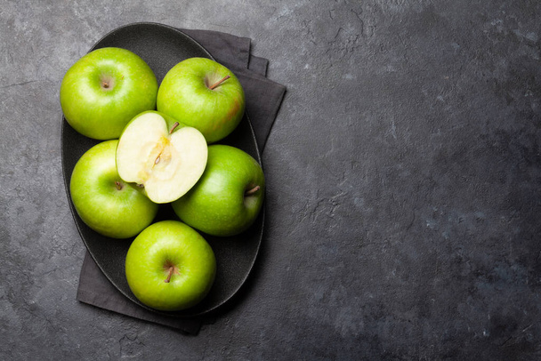 Ripe green apple fruits on dark stone table. Top view with copy space. Flat lay - Valokuva, kuva