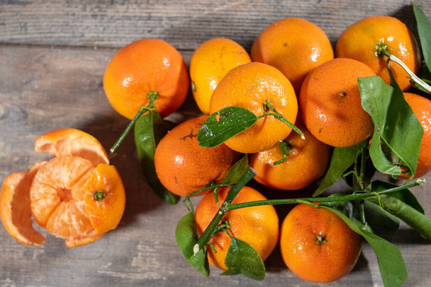the delicious tangerines on the wooden background - Photo, Image