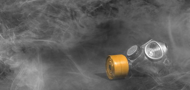 Vintage gasmask isolated on black background - Smoke in the room - Orange filter - Photo, Image