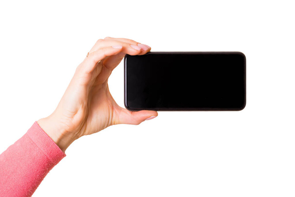 Cep telefonunu yatay olarak tutan kişi, beyaz arkaplanda izole edilmiş fotoğraf - Fotoğraf, Görsel