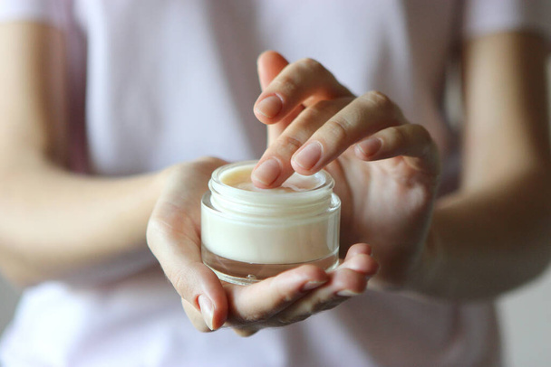 girl uses hand cream. Skin care, skin hydration. - Photo, Image