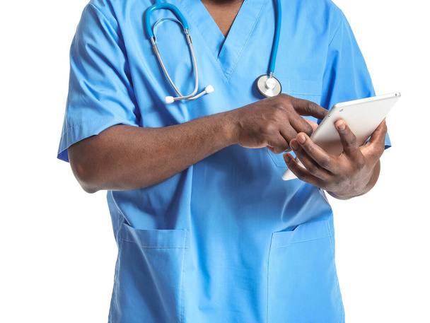 African-American doctor with tablet computer on white background - Foto, Bild