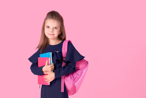 Back to school concept Half turned photo portrait of lovely confident beautiful clever girl with copybook notebook wearing school uniform dress pink bright backpack isolated - Zdjęcie, obraz