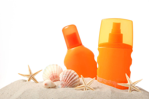 sand, shells, starfish and sunscreen isolated on white. Skin protection from the sun. - Photo, Image