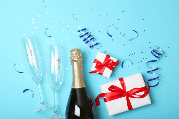 champagne, confetti, gifts and glasses on a colored background top view. Concept holiday, christmas, new year, birthday, valentines day. Celebrate, give. Place for text. - Foto, immagini