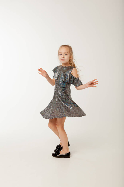 Little girl in sequin dress is dancing - Zdjęcie, obraz