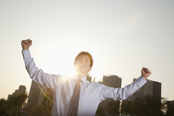 Businessman with fists in the air celebrating - Photo, Image
