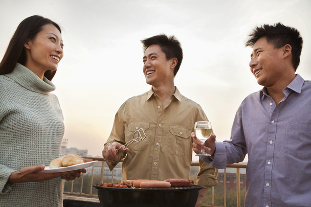 Group of Friends Having a Barbeque on a Rooftop - Photo, Image