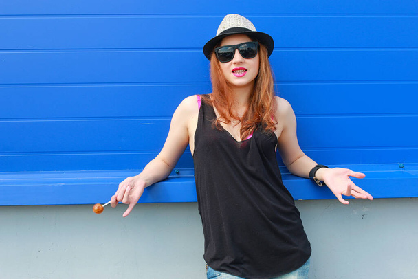 Girl hipster in a light hat and sunglasses on a summer day - Photo, Image