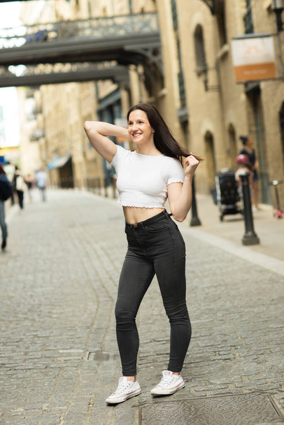 portrait of a happy young woman in the street - Photo, Image