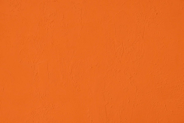 Saturated orange colored low contrast Concrete textured background with roughness and irregularities. 2020, 2021 color trend. - Photo, Image