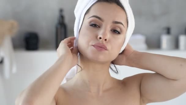 Portrait of beautiful woman dressing towel head. Looking at the camera. Handheld shot. - Felvétel, videó