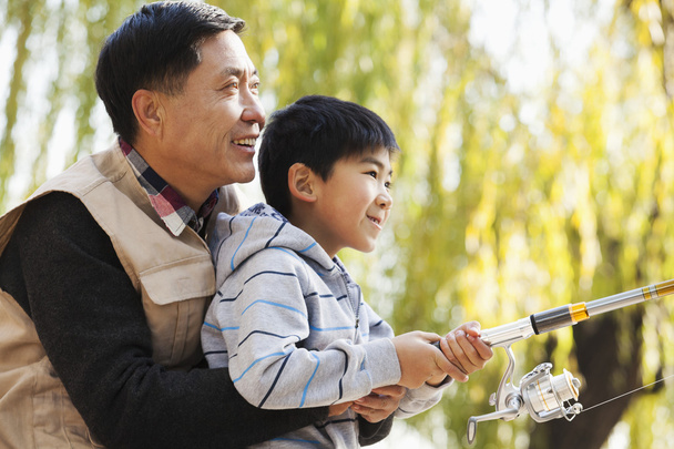 Grandfather and grandson fishing - Photo, Image