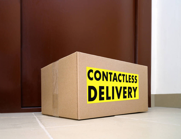 Contactless delivery. Left delivery box at the door during the quarantine. Apartment entrance with delivered box. Control Epidemic Prevention measures of coronavirus. - Photo, Image