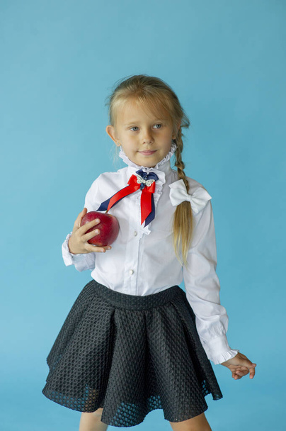 Шестилетняя девочка в белой футболке изолирована на синем фоне студии, симпатичная европейская внешность ребенок позирует закрытый улыбающийся взгляд на камеру, поколение Z концепции. Девочка школьница на синем фоне
 - Фото, изображение