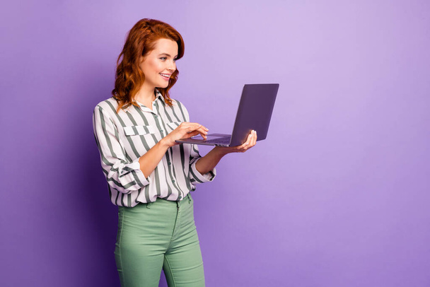 Portrait of positive cheerful cool smm worker woman use laptop have online conversation with colleagues wear good look clothing isolated over purple color background - Zdjęcie, obraz