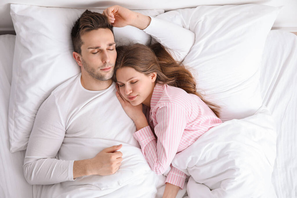 Young couple sleeping in bed - Photo, image