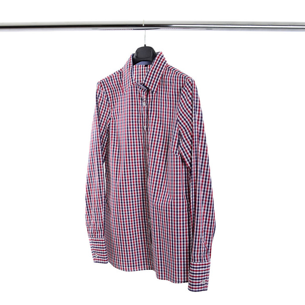 A plaid shirt hangs on the hanger isolated on white - Фото, зображення