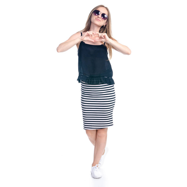 Woman in skirt with sunglasses standing smiling happiness showing heart - Fotografie, Obrázek