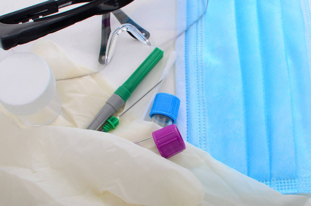 Sebészeti maszk, kesztyű, kémcső és tű a vírus kiürítéséhez - Fotó, kép