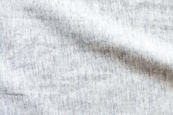 Close up shot to see the detail of heather grey knitted fabric made of synthetic fibres background. abstract wallpaper clothing or soft textile with copy space for text. - Photo, Image