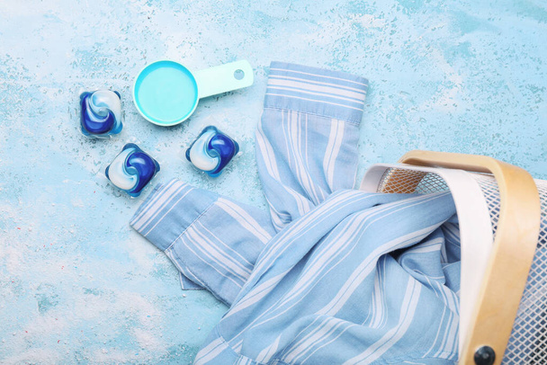 Zusammensetzung mit Kleidung und Waschmitteln auf farbigem Hintergrund - Foto, Bild