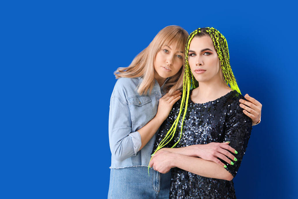 Portrait of young transgender couple on color background - Photo, Image