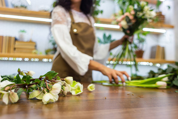 Attractive young woman florist is working in a flower shop. - Valokuva, kuva