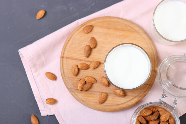 Almond milk and almonds on the table. Vegetable milk. Vegetarian milk. - Valokuva, kuva