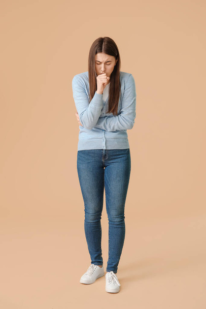 Coughing young woman on color background - Foto, Imagen
