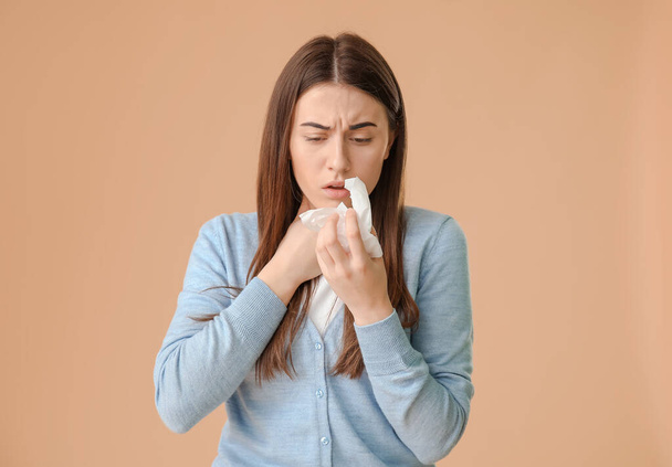 Coughing young woman on color background - Photo, Image