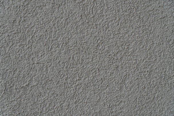 Background image of a wall covered with textured paint. Wallpaper. Substrate for text. Detailed texture of decorative stucco. Wall in the interior and exterior. Top view. - Fotoğraf, Görsel