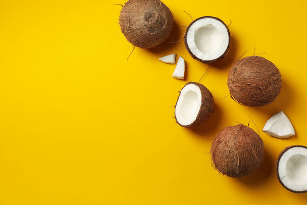 Flat lay with coconut on yellow background, space for text - Valokuva, kuva