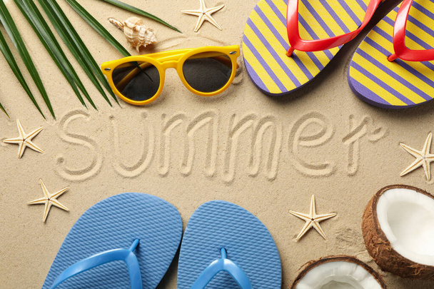 Composition with vacation accessories and inscription Summer on sea sand background - Foto, Bild