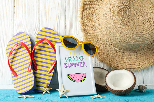 Frame with Hello summer and vacation accessories on wooden background, close up - Photo, Image