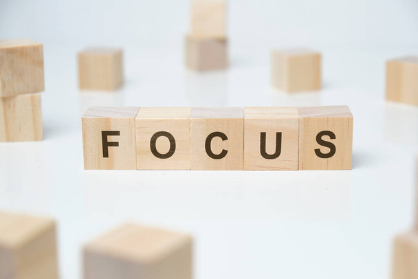 Modern business buzzword - focus. Word on wooden blocks on a white background. Close up. - Foto, afbeelding